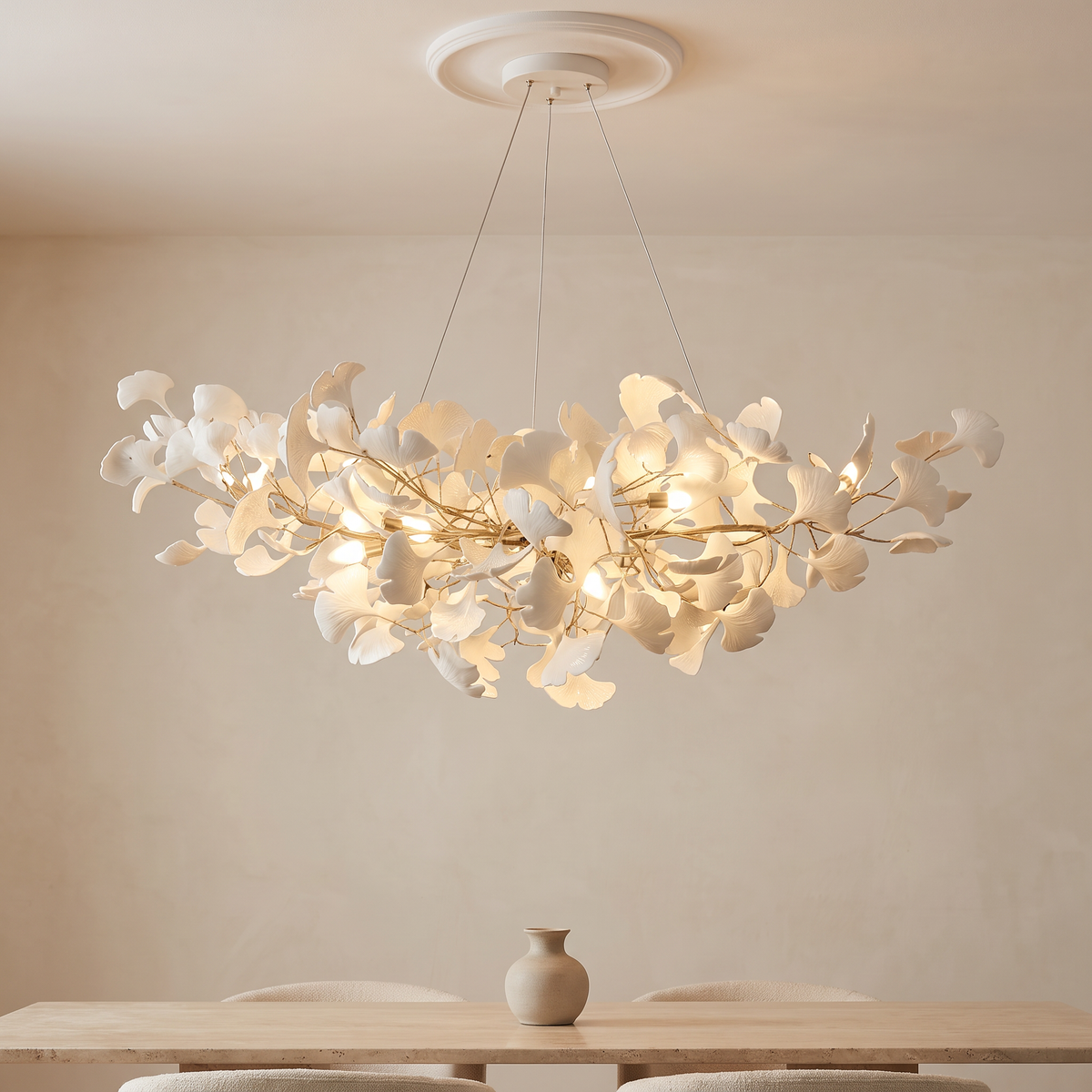 Porcelain Ginkgo Leaf Linear Chandelier lit above a dining table in a modern Italian dining room