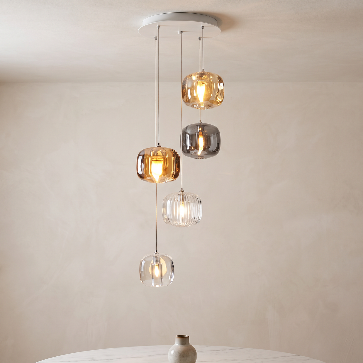 Amber, Smoke and Clear Crystal Pendant Chandelier above a dining table in a modern Italian dining room