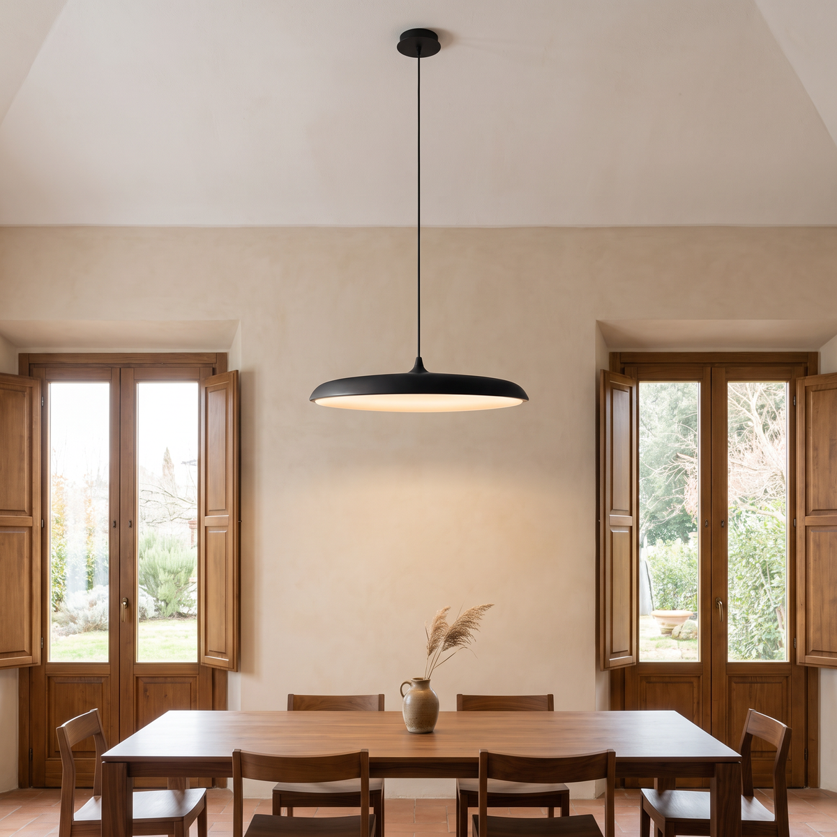 Bauhaus Disc Pendant Light high above a dining table in an Italian dining room